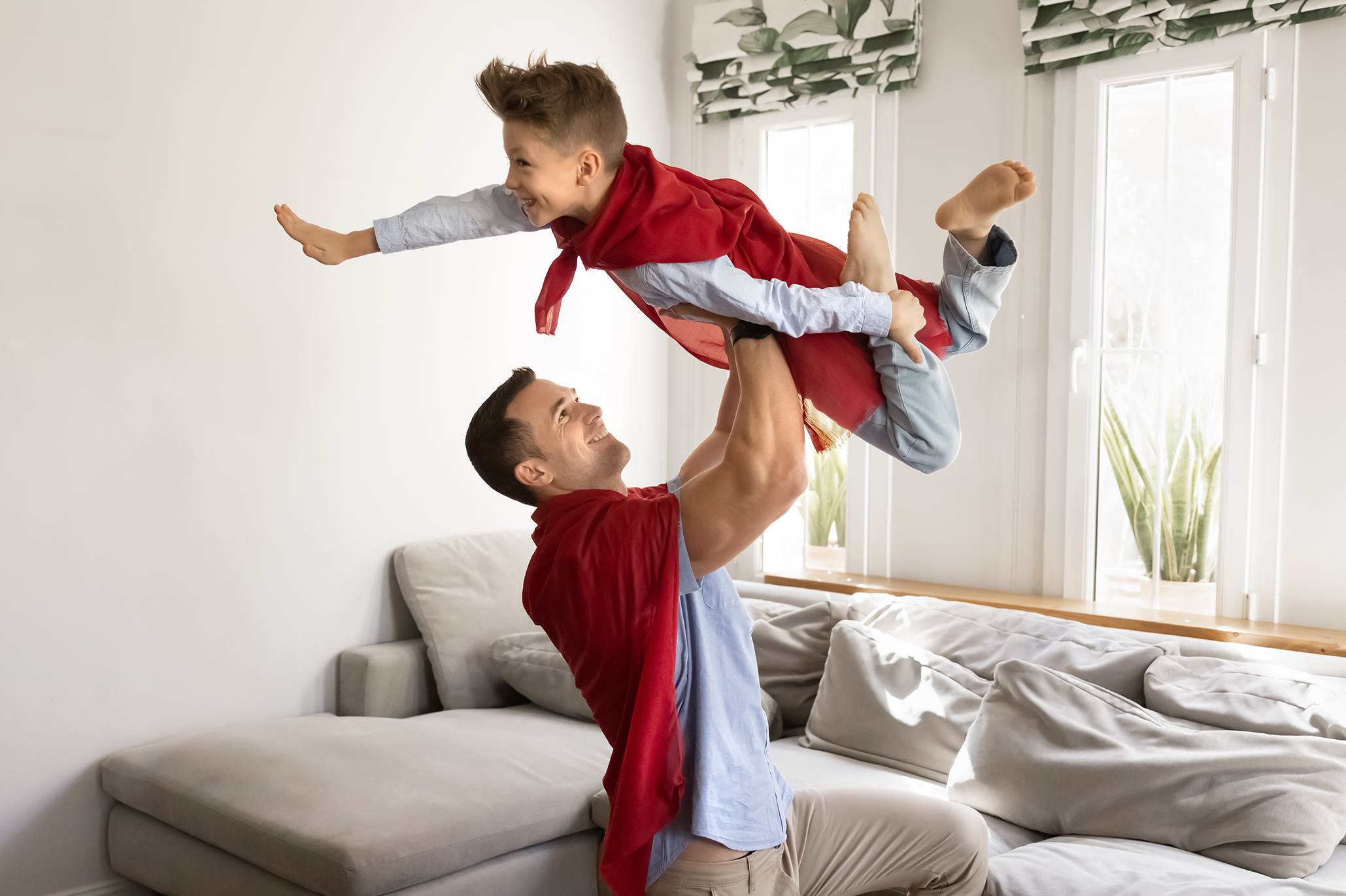Dad holding a kid over his head as a superhero